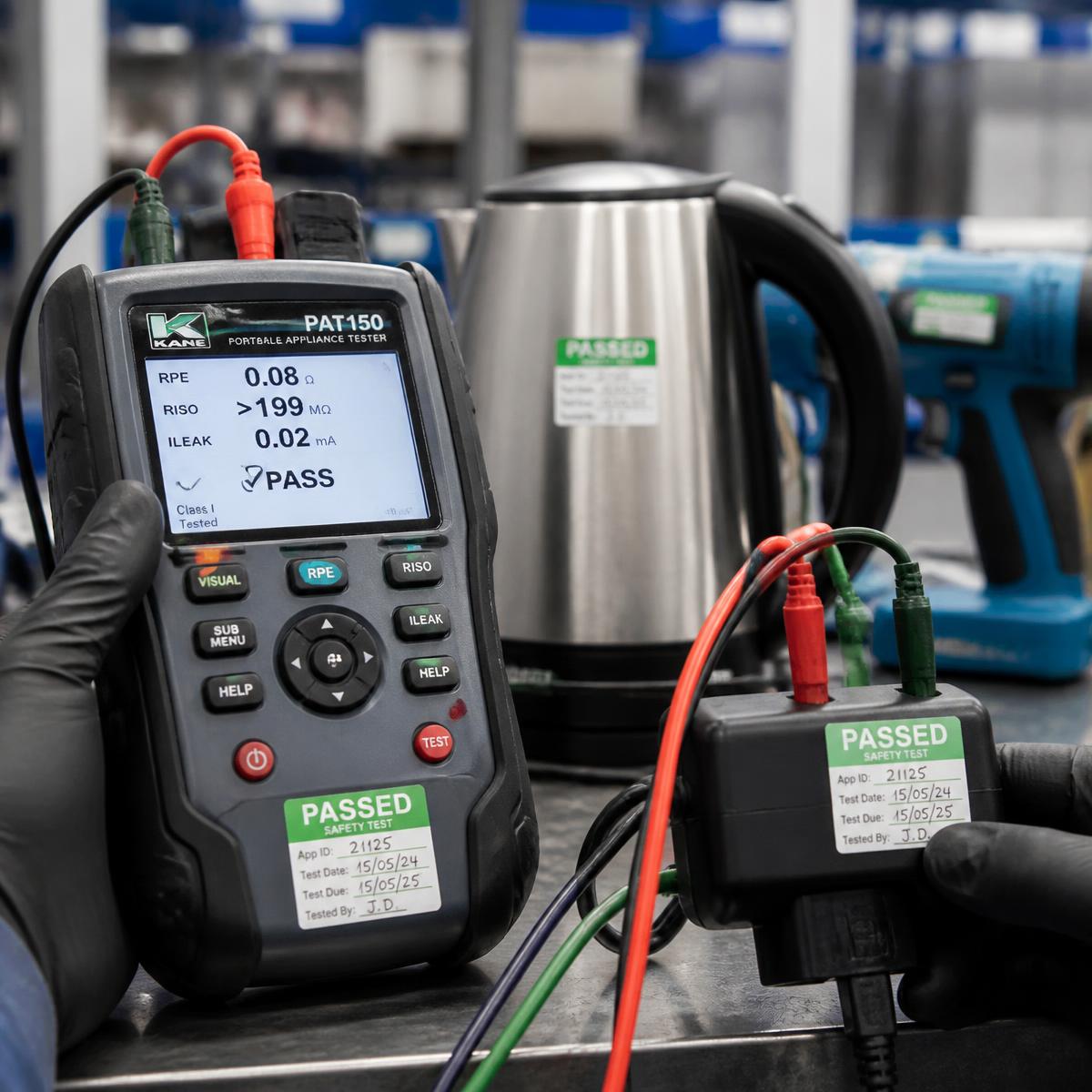 Portable appliance tester in use with a PASSED safety test label